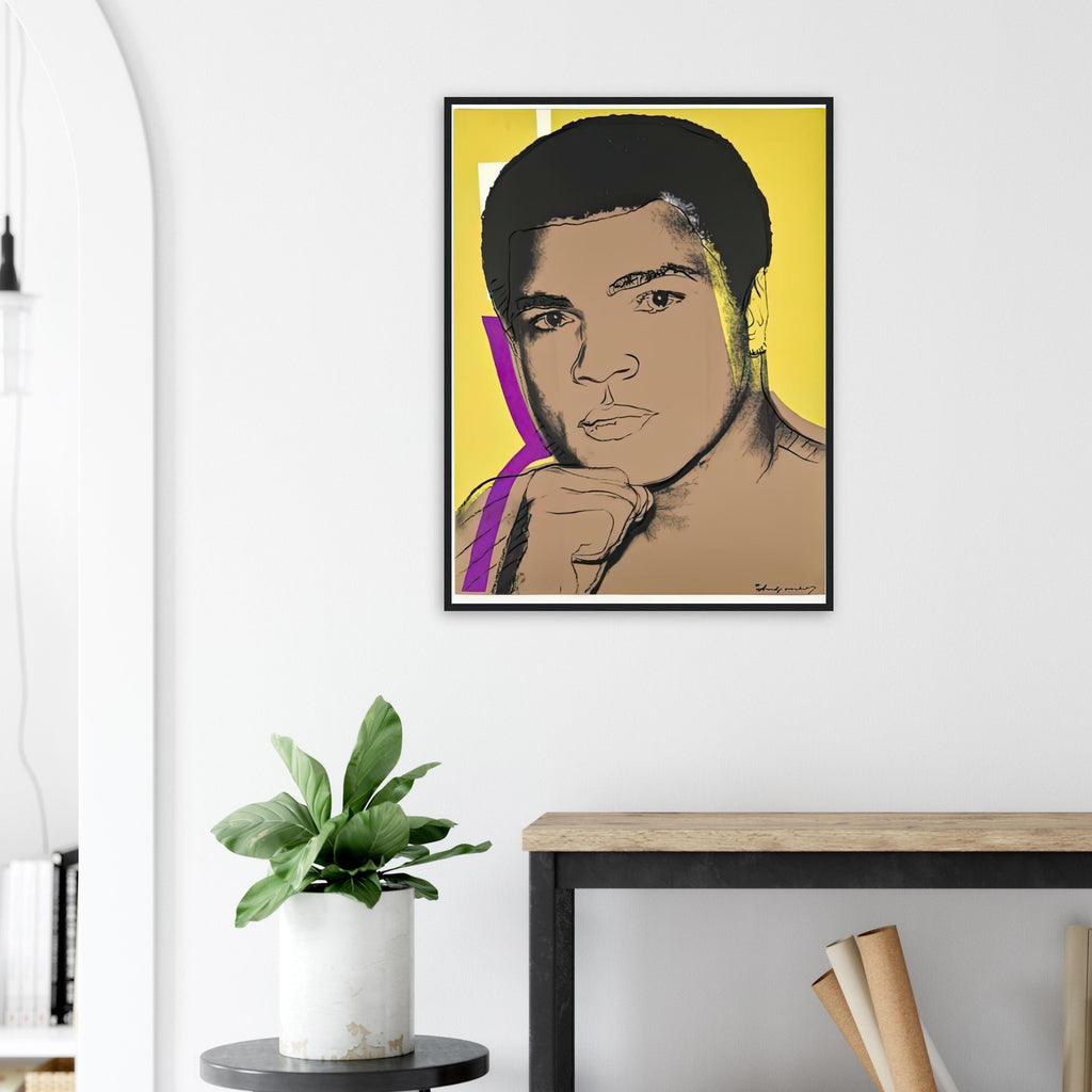 Andy Warhol framed print depicting ali turns toward the viewer with a raised fist; yellow, purple and white colour accents sharpen his focused gaze; The Muhammad Ali portfolio was developed from Warhol’s photographs of the celebrated boxer after sports