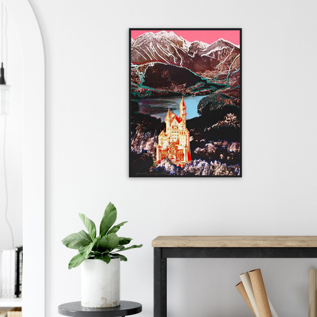 Andy Warhol framed print depicting the Bavarian castle glows in orange-red and yellow above a lake, while blue outlines and a bright-pink sky dominate the Alpine setting; Warhol’s image of Neuschwanstein Castle translates a heavily photographed Bavarian landmark into Pop Art