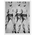 Andy Warhol framed print depicting a repeated standing figure in Western costume amplifies the rhythm of the pose, blending the visual language of a publicity still with a repeated screen image; Warhol’s multiple-Elvis imagery grew from publicity photographs of Elvis Presley in his Western-film, white frame, 27x35 cm / 11x14″