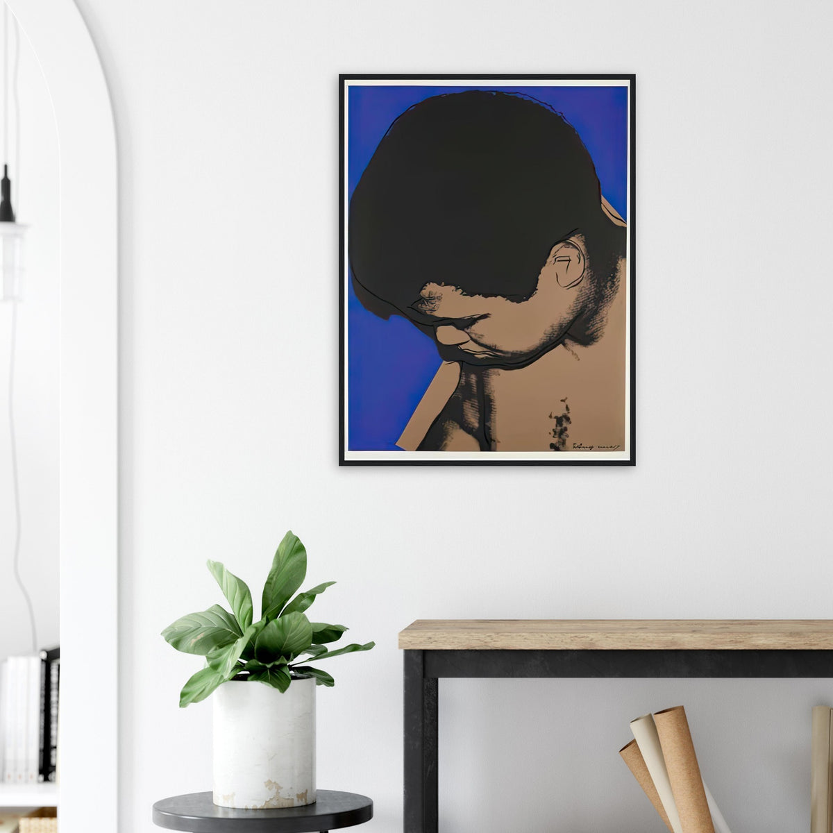 Andy Warhol framed print depicting ali lowers his head toward the left as cobalt blue frames the shoulders and face, making his expression partly hidden; The Muhammad Ali portfolio was developed from Warhol’s photographs of the celebrated boxer after sports