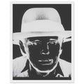 Andy Warhol framed print depicting beuys faces the viewer wearing his characteristic brimmed felt hat; Warhol portrayed fellow artist Joseph Beuys after photographing him in 1979, white frame, 27x35 cm / 11x14″