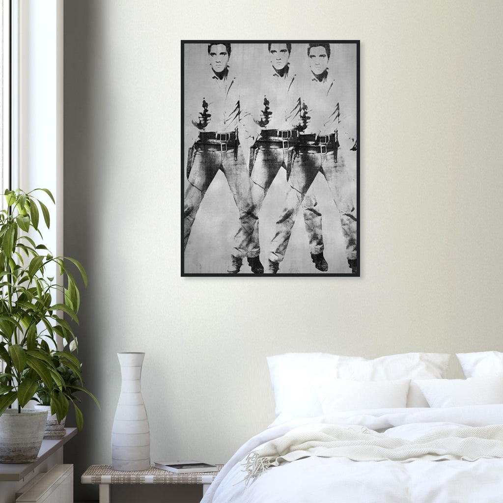 Andy Warhol framed print depicting a repeated standing figure in Western costume amplifies the rhythm of the pose, blending the visual language of a publicity still with a repeated screen image; Warhol’s multiple-Elvis imagery grew from publicity photographs of Elvis Presley in his Western-film