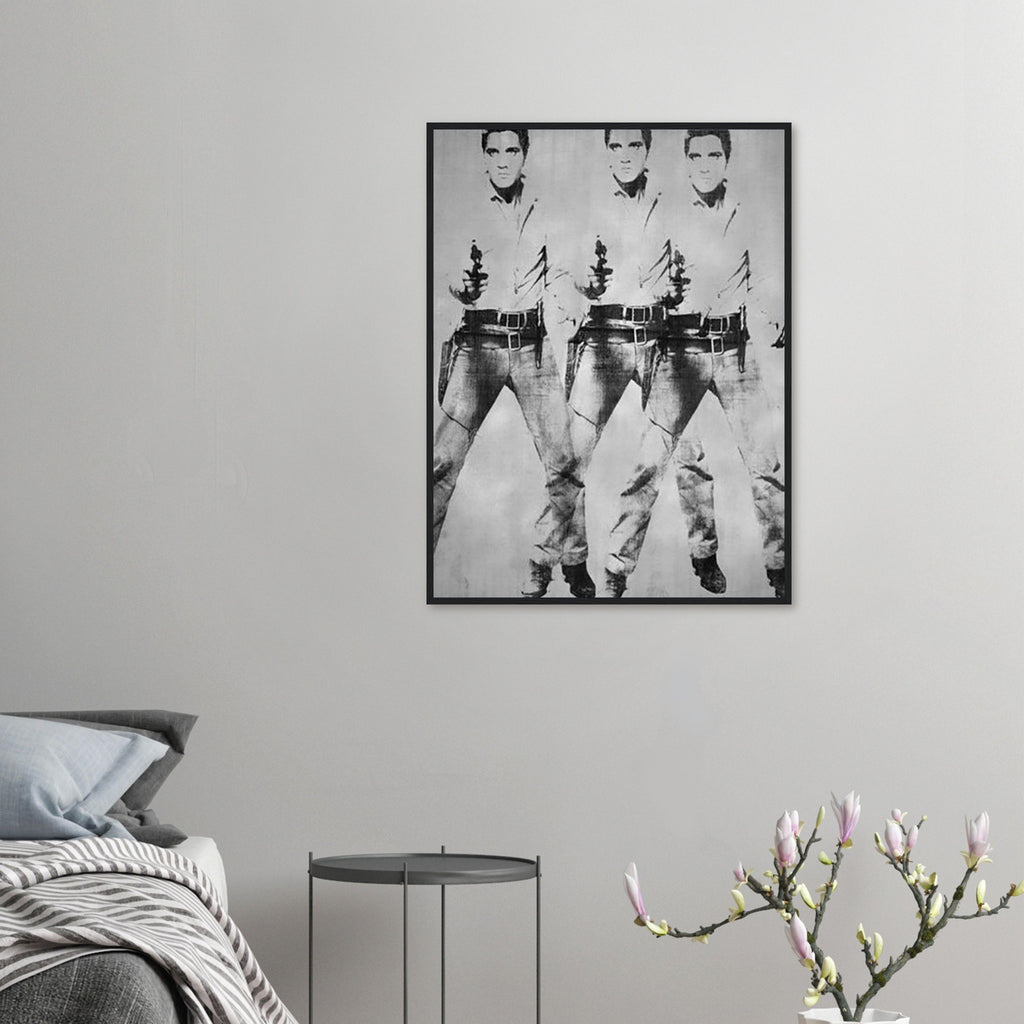 Andy Warhol framed print depicting a repeated standing figure in Western costume amplifies the rhythm of the pose, blending the visual language of a publicity still with a repeated screen image; Warhol’s multiple-Elvis imagery grew from publicity photographs of Elvis Presley in his Western-film